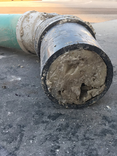 Removal Of A Section Of Clogged Pipe At Manufacturing Facility The
